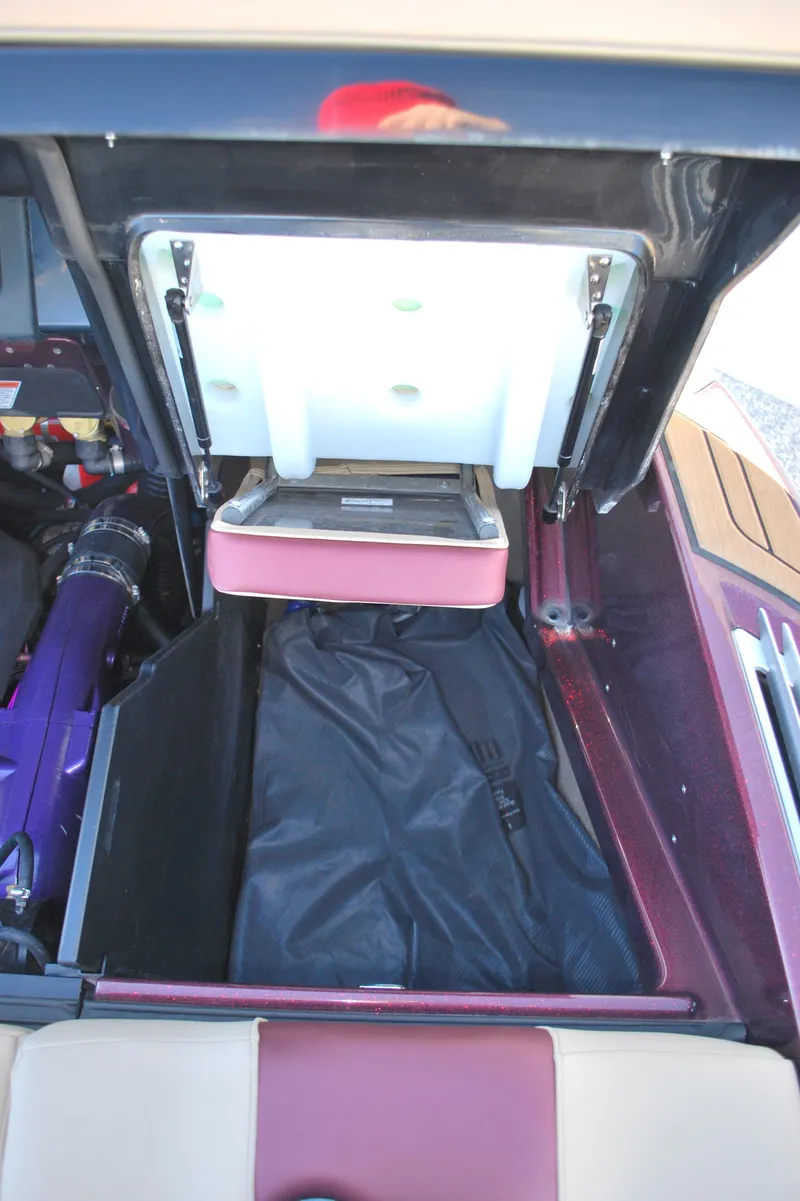 Slide: The Image of 2023 MasterCraft X24 storage compartment with open lid and visible interior. - 22