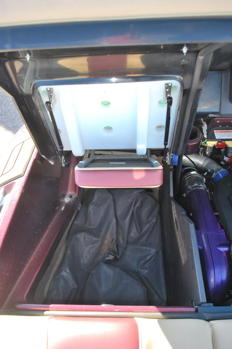 Slide: The Image of 2023 MasterCraft X24 boat storage compartment with open lid. - 23