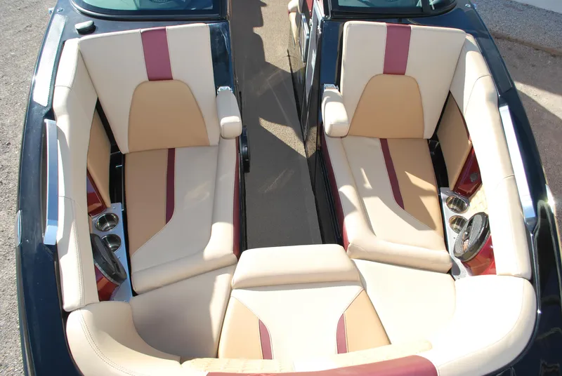 Slide: The Image of 2023 MasterCraft X24 boat interior with beige and maroon seating. - 6