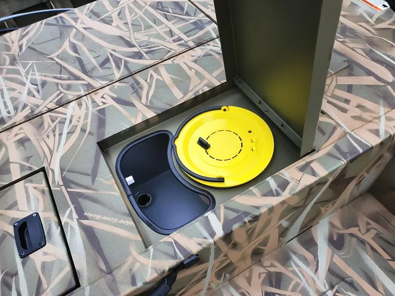 Slide: The Image of Camouflage-patterned Lowe Outlet 20 boat with open storage compartment, featuring a yellow lid, 2025 model. - 12