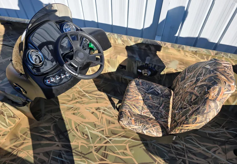 Slide: The Image of 2025 Lowe Outlet 20 boat interior with camouflage seating and steering console. - 2