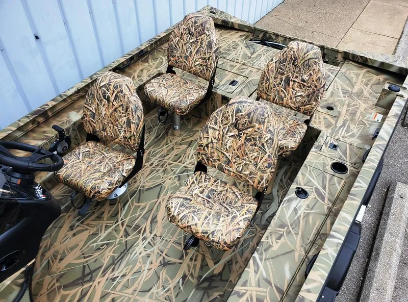 Slide: The Image of 2025 Lowe Outlet 20 boat with camouflage seating and deck, ideal for outdoor adventures. - 7