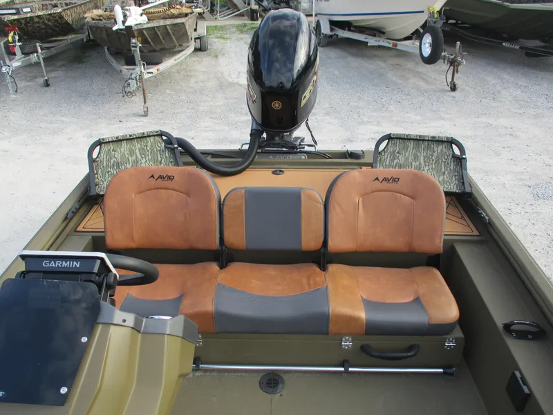 Slide: The Image of 2025 Avid 18 Rogue SC boat interior with brown seats and Garmin equipment. - 9