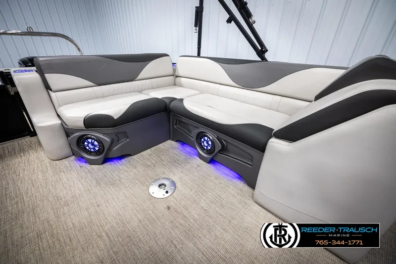 Slide: The Image of 2023 Avalon LSZ CRB boat interior with plush seating and blue LED lighting. - 23
