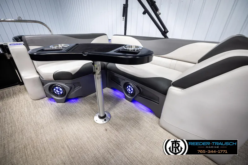 Slide: The Image of 2023 Avalon LSZ CRB boat interior with seating, table, and blue LED lighting. - 24