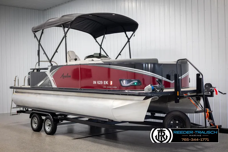 Slide: The Image of 2023 Avalon LSZ CRB pontoon boat on trailer in indoor showroom. - 3