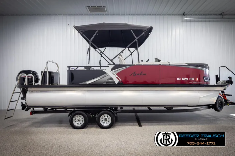 Slide: The Image of 2023 Avalon LSZ CRB pontoon boat with canopy on trailer in showroom. - 5