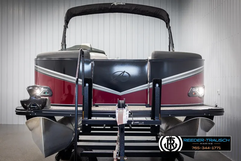 Slide: The Image of 2023 Avalon LSZ CRB pontoon boat with red and black design in showroom. - 8
