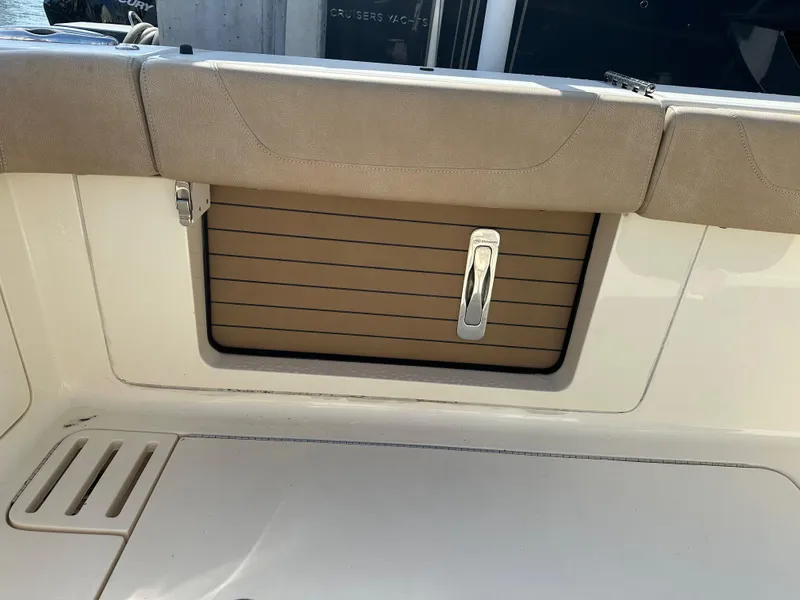 Slide: The Image of 2019 Scout 380 LXF boat interior with cushioned seating and storage compartment. - 10