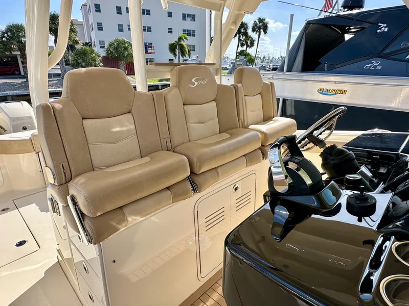 Slide: The Image of 2019 Scout 380 LXF boat interior with beige seating and modern helm controls. - 15