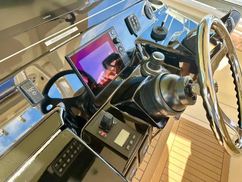 Slide: The Image of Control panel of 2019 Scout 380 LXF boat with steering wheel and navigation equipment. - 17