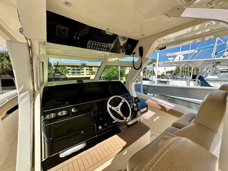 Slide: The Image of Interior view of 2019 Scout 380 LXF boat cockpit with steering wheel and controls. - 18