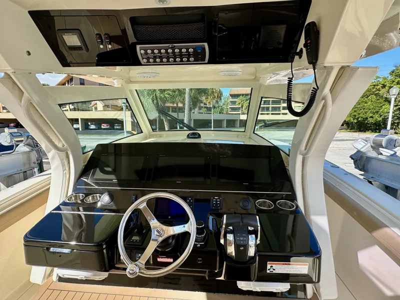 Slide: The Image of 2019 Scout 380 LXF boat helm with modern controls and steering wheel. - 19