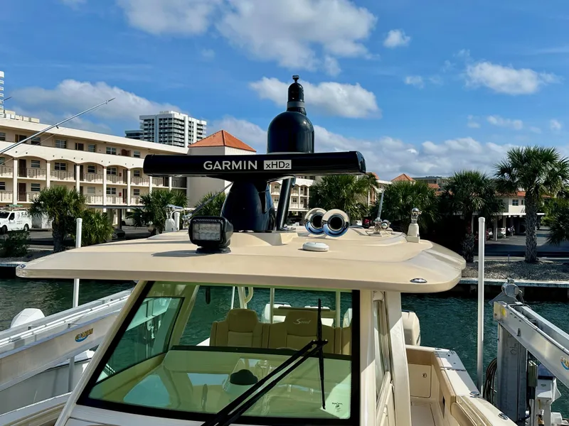 Slide: The Image of 2019 Scout 380 LXF boat with Garmin xHD2 radar, docked near waterfront buildings. - 20