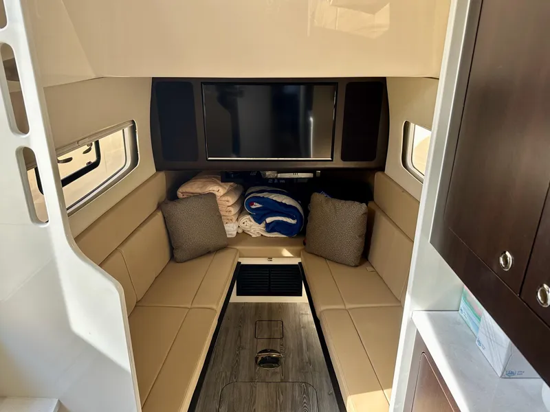 Slide: The Image of Luxurious interior of 2019 Scout 380 LXF boat with seating and TV. - 23