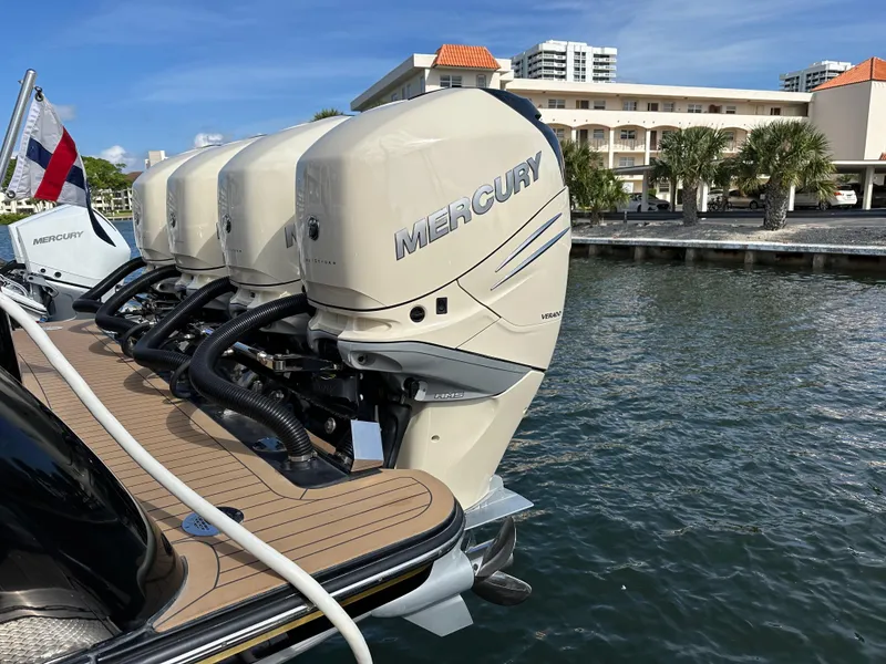 Slide: The Image of 2019 Scout 380 LXF with Mercury outboard engines docked by waterfront buildings. - 26