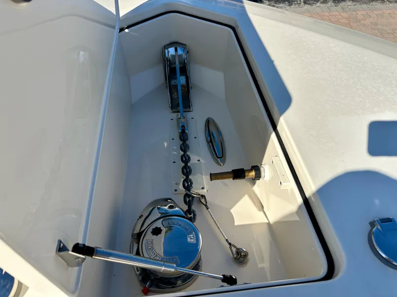 Slide: The Image of Anchor compartment of 2019 Scout 380 LXF boat, featuring chain and winch system. - 27