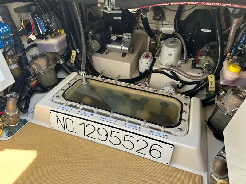 Slide: The Image of Engine compartment of a 2019 Scout 380 LXF boat, showcasing mechanical components and wiring. - 29