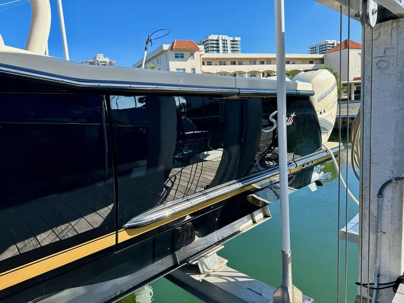 Slide: The Image of 2019 Scout 380 LXF boat docked, reflecting water and buildings. - 3