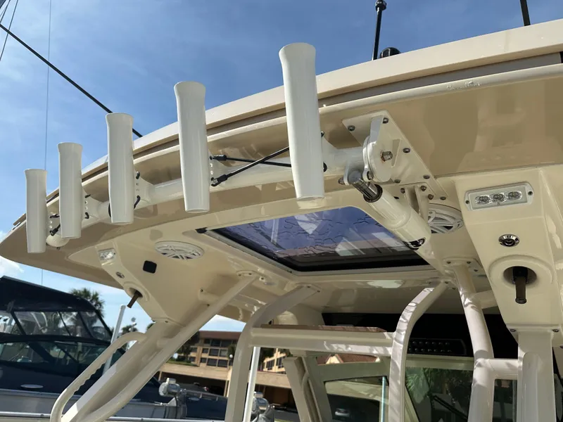 Slide: The Image of 2019 Scout 380 LXF boat with rod holders and sunroof detail. - 5
