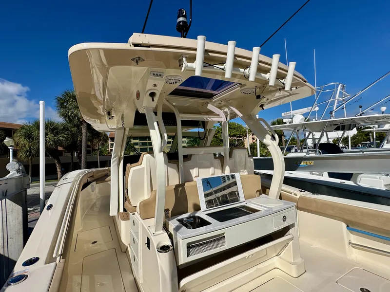 Slide: The Image of 2019 Scout 380 LXF boat interior with seating and fishing rod holders. - 7