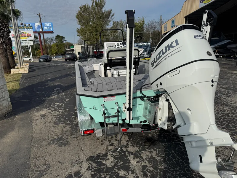 Slide: The Image of 2025 Vexus ACX 2210 boat with Suzuki 250 outboard motor, parked on a street. - 10