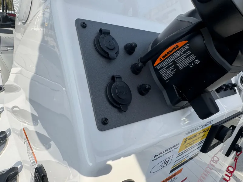 Slide: The Image of Close-up of 2025 Vexus ACX 2210 boat dashboard with warning label and controls. - 17