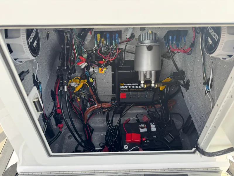 Slide: The Image of 2025 Vexus ACX 2210 boat electrical compartment with wiring and battery setup. - 24