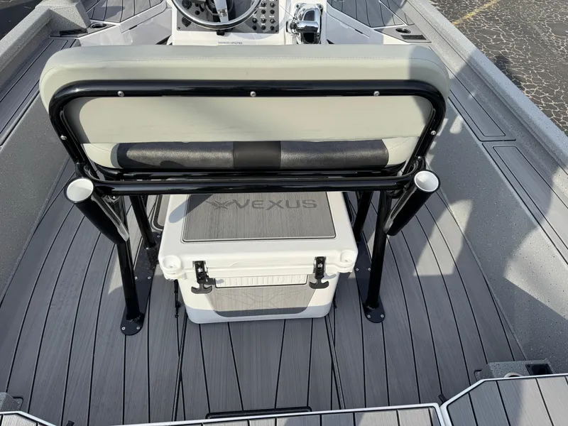 Slide: The Image of 2025 Vexus ACX 2210 boat interior with seating and storage cooler. - 28