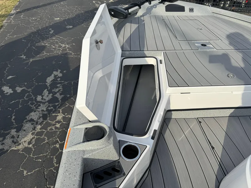 Slide: The Image of 2025 Vexus ACX 2210 boat deck with open storage compartment and cup holder. - 30