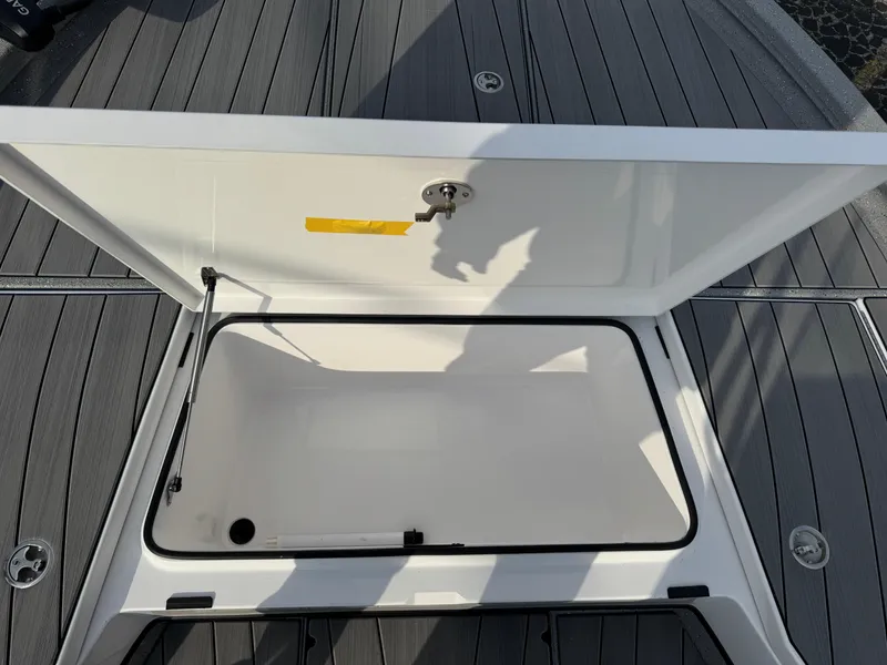 Slide: The Image of Open storage compartment on 2025 Vexus ACX 2210 boat deck. - 31
