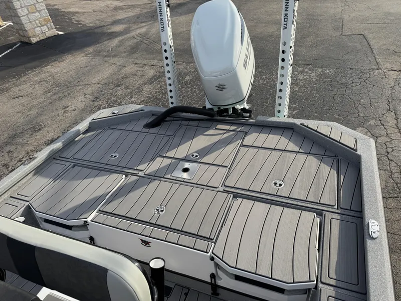 Slide: The Image of 2025 Vexus ACX 2210 boat deck with motor, featuring sleek design and storage compartments. - 38