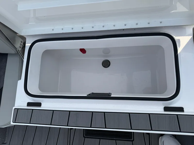 Slide: The Image of Vexus ACX 2210 2025 boat storage compartment with open lid, showcasing interior space. - 43