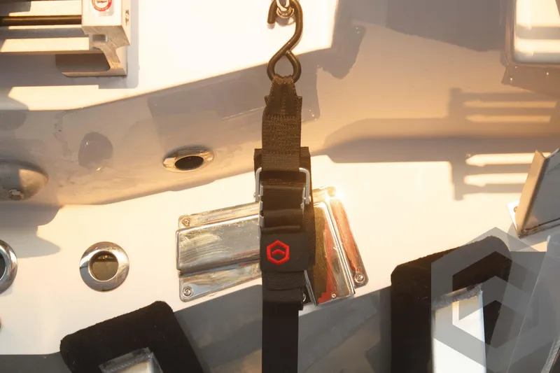 Slide: The Image of Caymas 26 HB 2025 boat deck with strap and hook detail. - 22