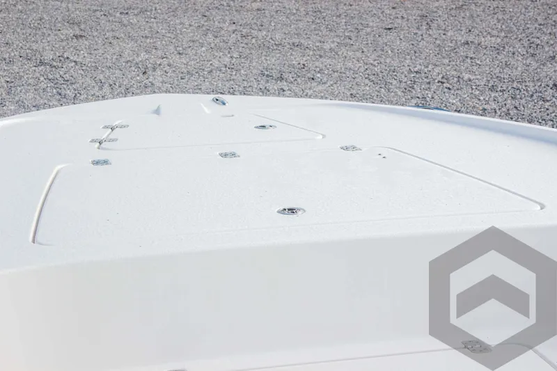 Slide: The Image of Bow deck of 2025 Caymas 26 HB boat on gravel surface. - 24