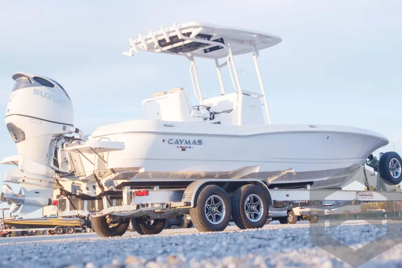 Slide: The Image of 2025 Caymas 26 HB boat on trailer, side view, outdoors. - 3
