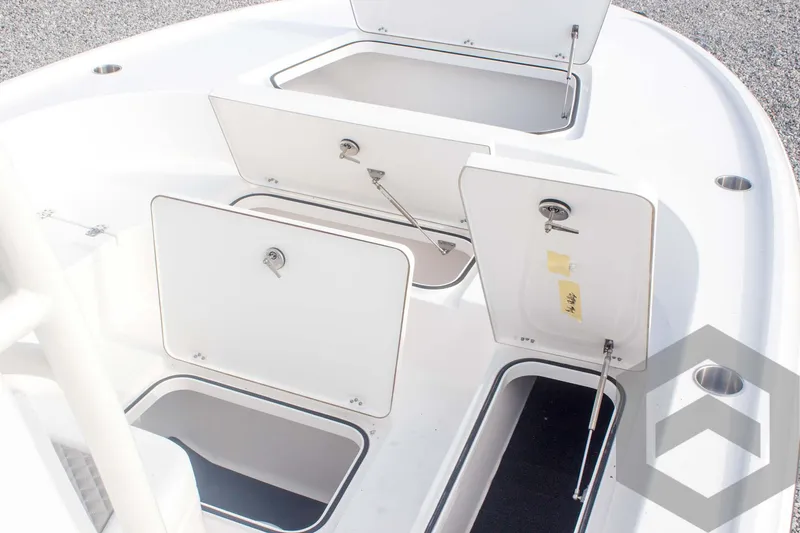 Slide: The Image of 2025 Caymas 26 HB boat storage compartments open on deck. - 31
