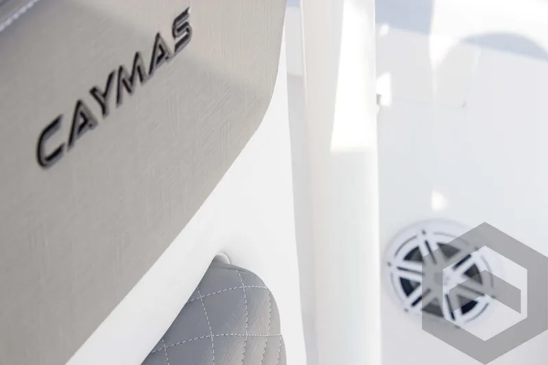 Slide: The Image of 2025 Caymas 26 HB boat interior with logo and speaker detail. - 36