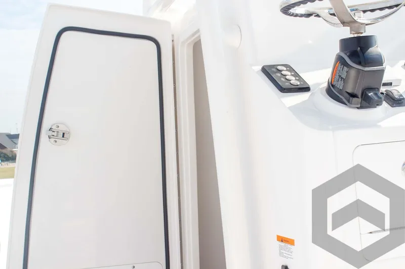 Slide: The Image of 2025 Caymas 26 HB boat console with steering wheel and storage compartment. - 39