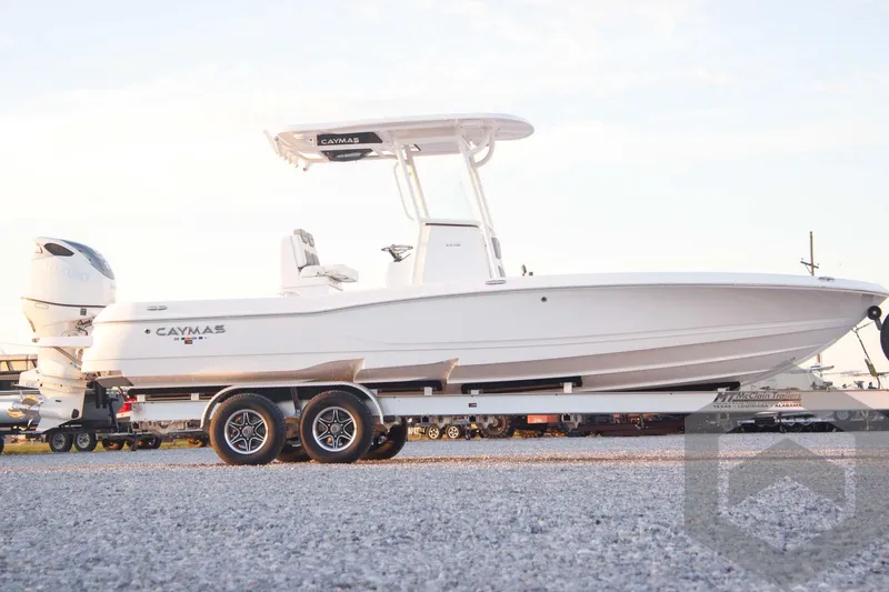 Slide: The Image of 2025 Caymas 26 HB boat on trailer, side view, white hull, dual axles. - 4