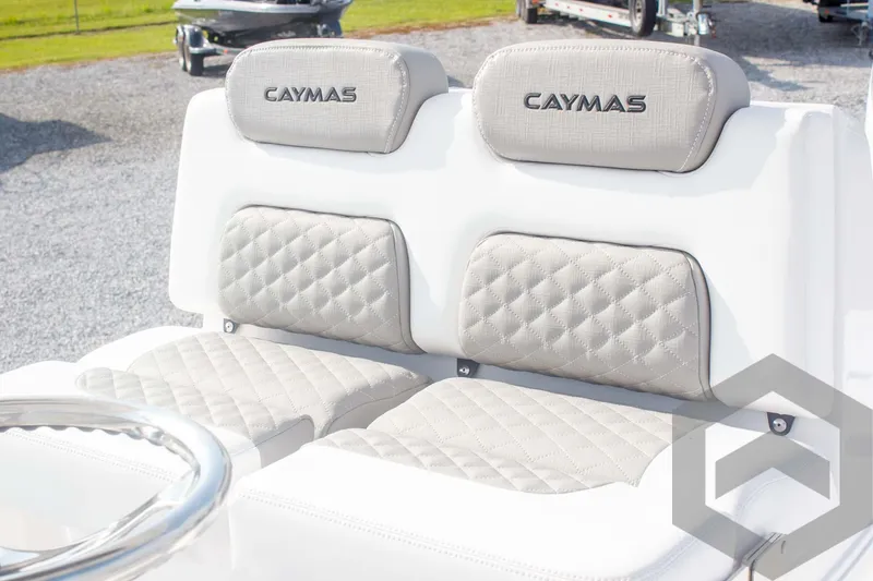 Slide: The Image of 2025 Caymas 26 HB boat seats with quilted upholstery and branded headrests. - 42