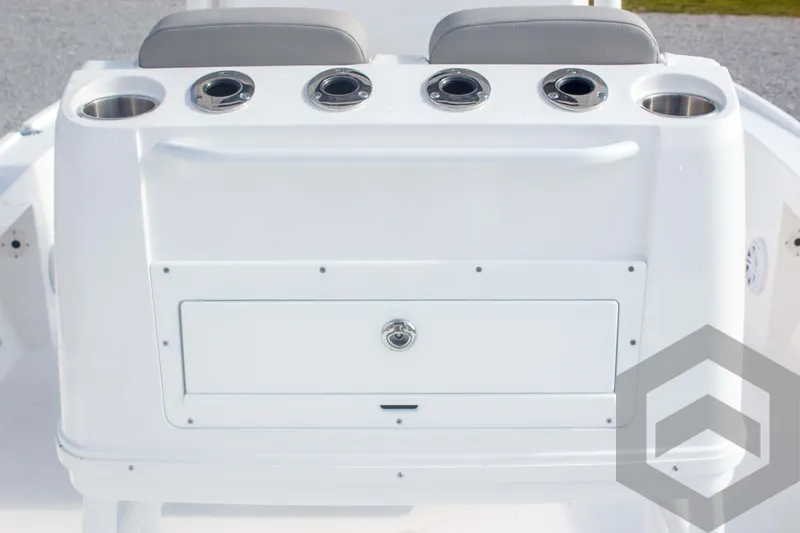 Slide: The Image of 2025 Caymas 26 HB boat console with cup holders and storage compartment. - 44