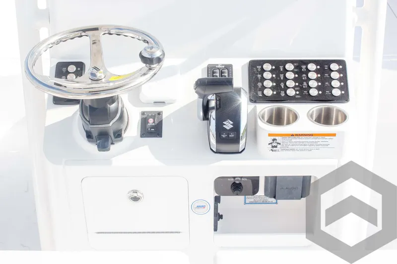 Slide: The Image of 2025 Caymas 26 HB boat console with steering wheel, controls, and cup holders. - 47
