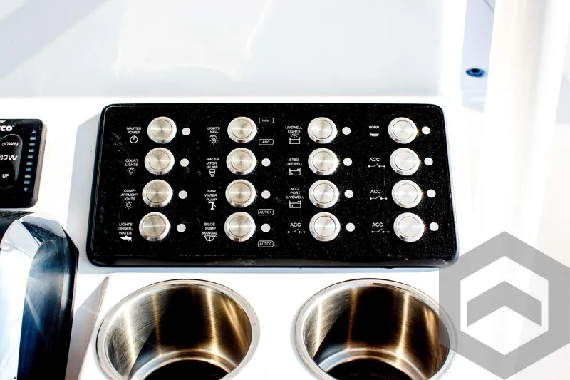 Slide: The Image of Control panel of 2025 Caymas 26 HB boat with stainless steel cup holders. - 48