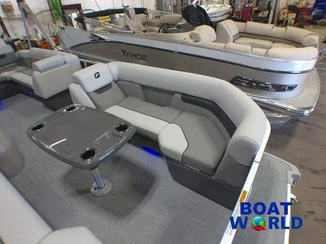 Slide: The Image of 2025 Princecraft Vectra 23 RL pontoon with lounge seating and table, showcased at Boat World. - 11