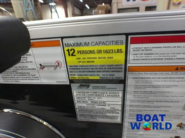Slide: The Image of Princecraft Vectra 23 RL pontoon capacity label, 12 persons or 1623 lbs, at Boat World. - 17