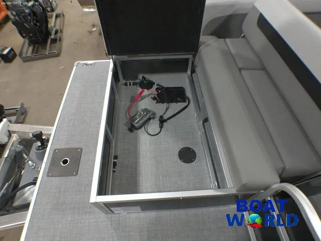 Slide: The Image of 2025 Princecraft Vectra 23 RL pontoon storage compartment with wiring, gray upholstery, and Boat World logo. - 21