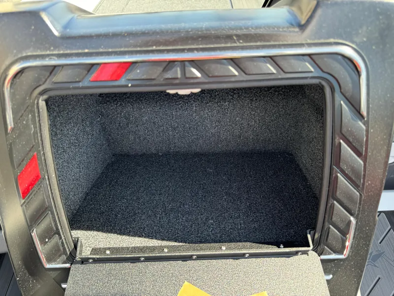Slide: The Image of 2025 Vexus DVX20S storage compartment, open and empty, with textured interior. - 11
