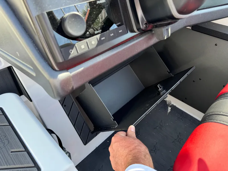 Slide: The Image of 2025 Vexus DVX20S boat dashboard with open storage compartment. - 16