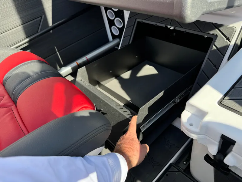 Slide: The Image of 2025 Vexus DVX20S boat interior with open storage compartment and red seat. - 17